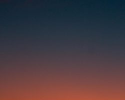 Fiery sunset with crescent moon Crescent moon and fiery orange sunset horizon