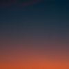 Fiery sunset with crescent moon Crescent moon and fiery orange sunset horizon